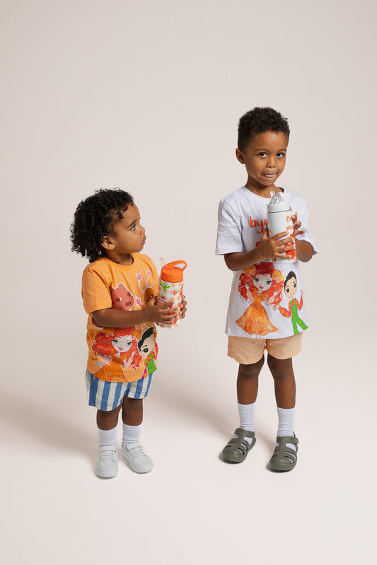 Child holding Emma Memma White Drink Bottle outdoors
