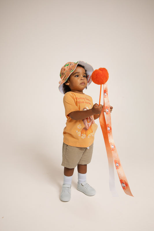 Child waving Emma Memma Pom Pom Twirly Ribbon dancing