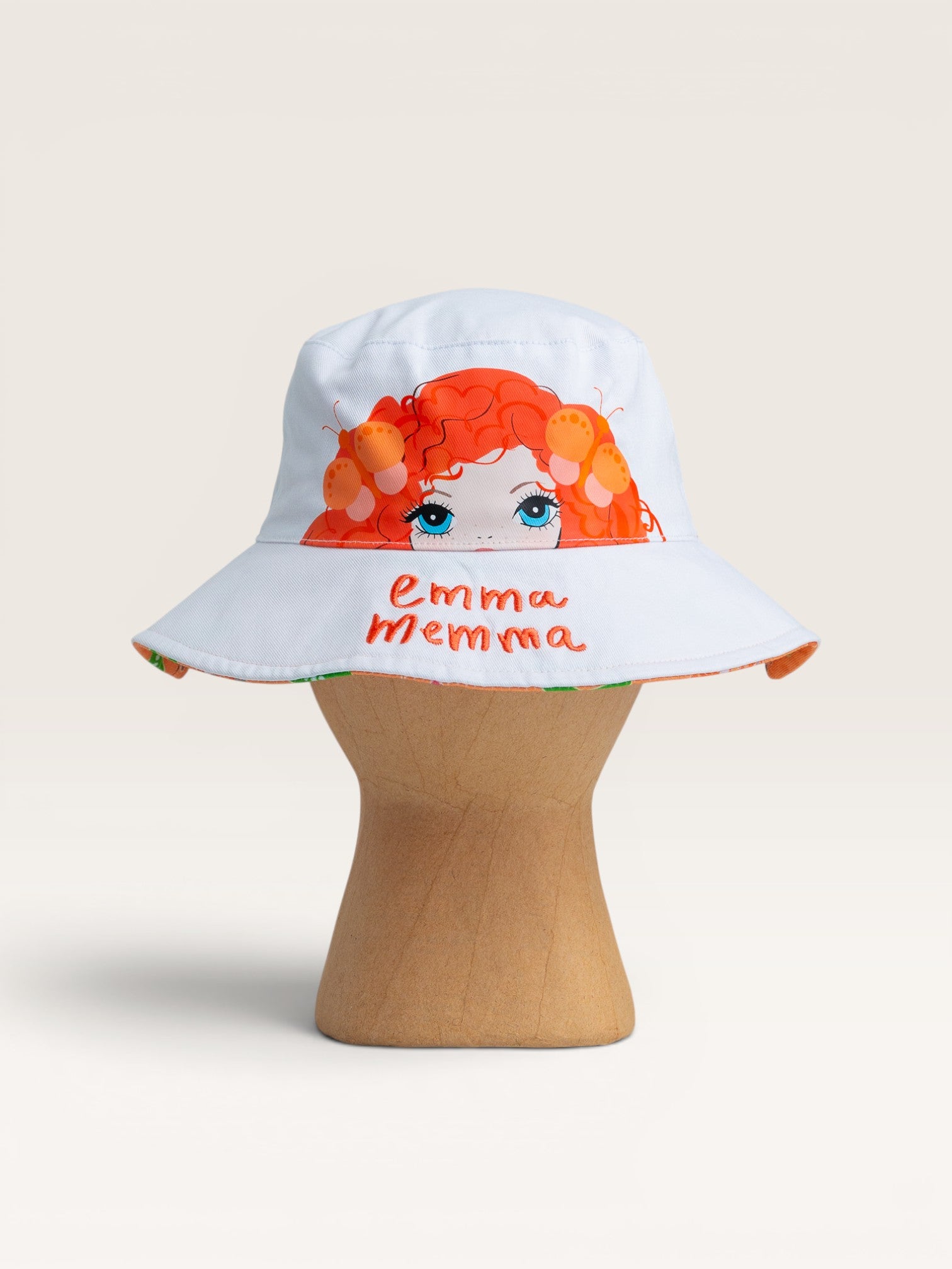 Child wearing Emma Memma reversible bucket hat Emma Memma side