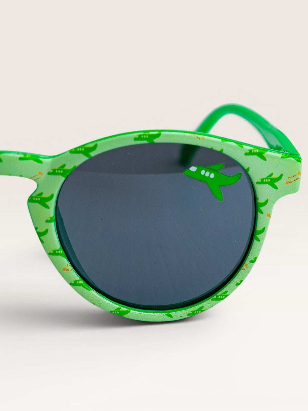 Child wearing Emma Memma Green Plane Sunglasses outdoors