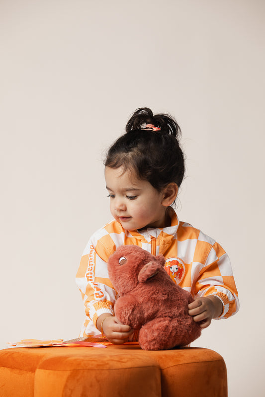 Waffles the Wombat large plush toy being hugged by a toddler
