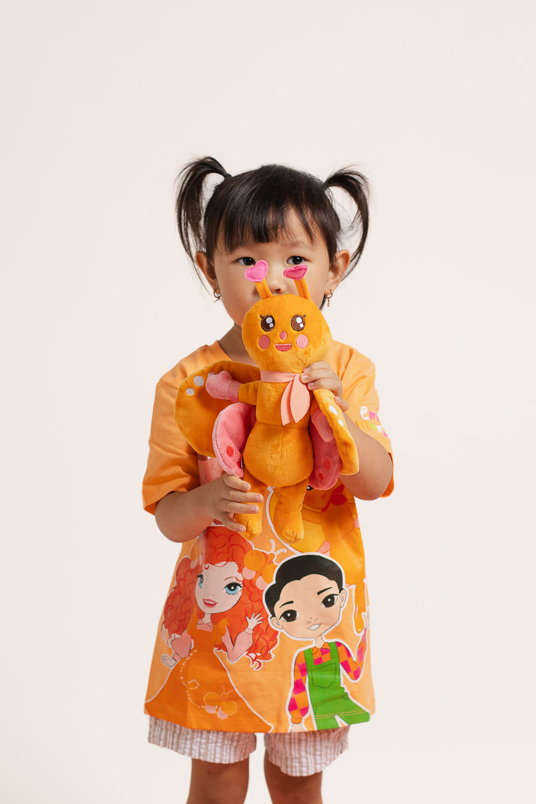 BB Butterfly plush toy being held by a child showing size