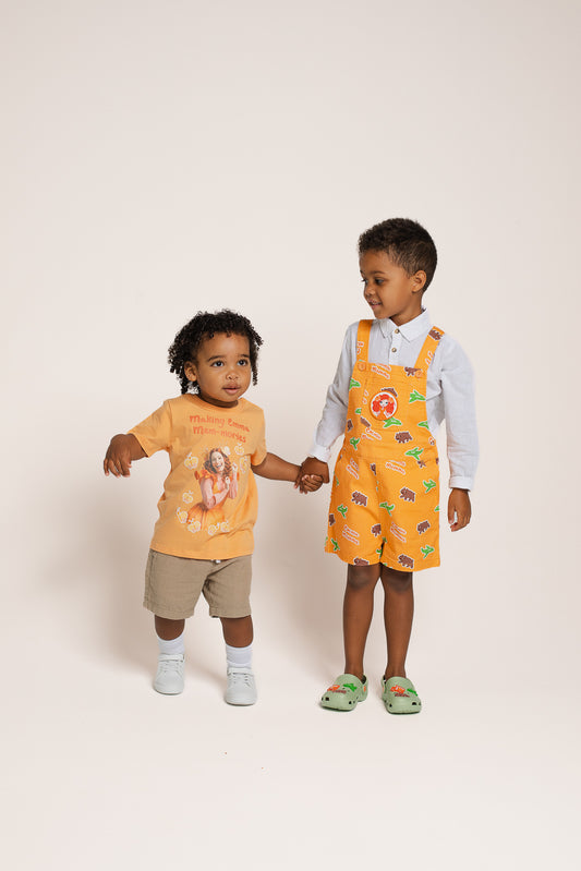Child wearing Emma Memma orange Mem-mories t-shirt outdoors