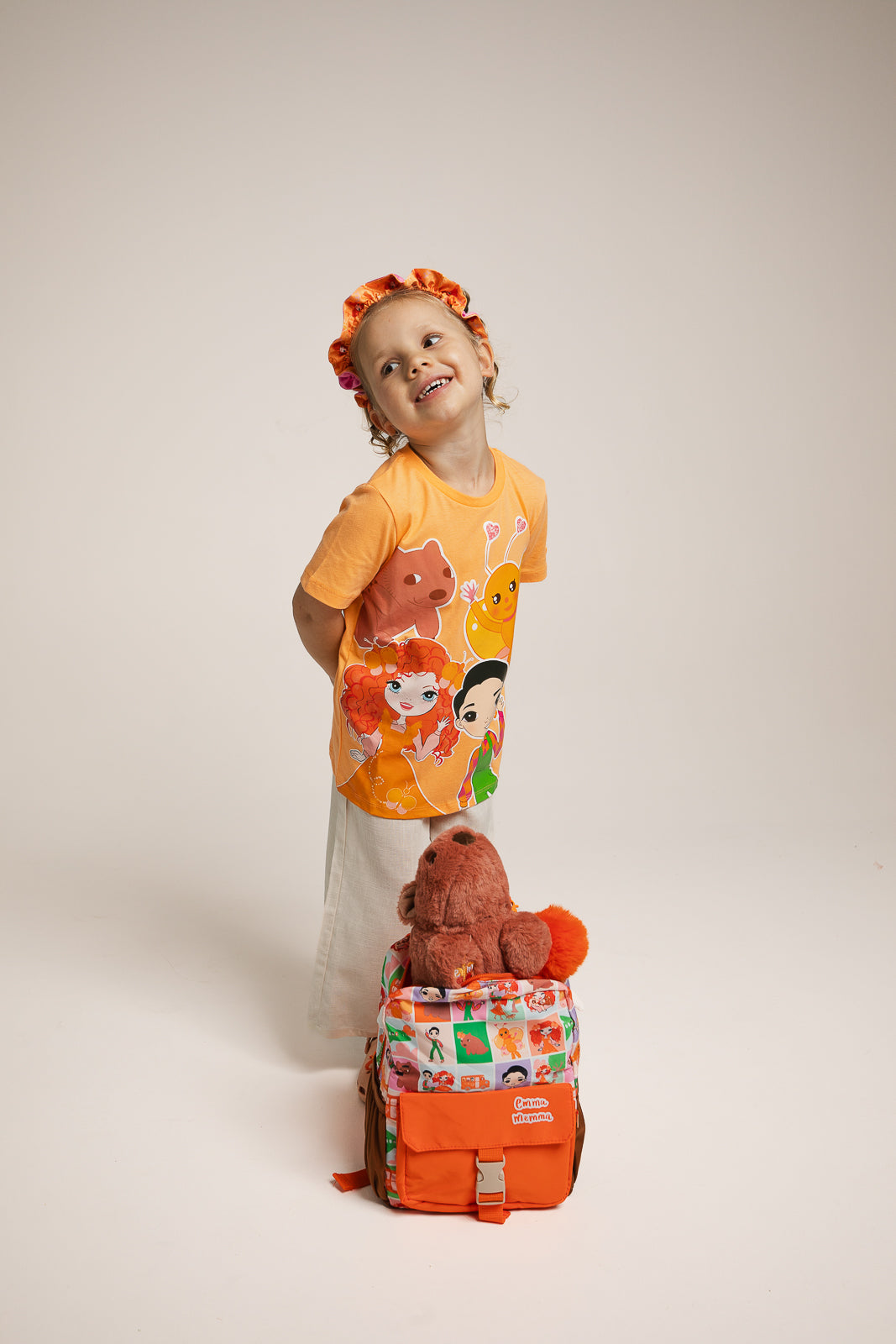 Child wearing Emma Memma characters t-shirt outdoors smiling