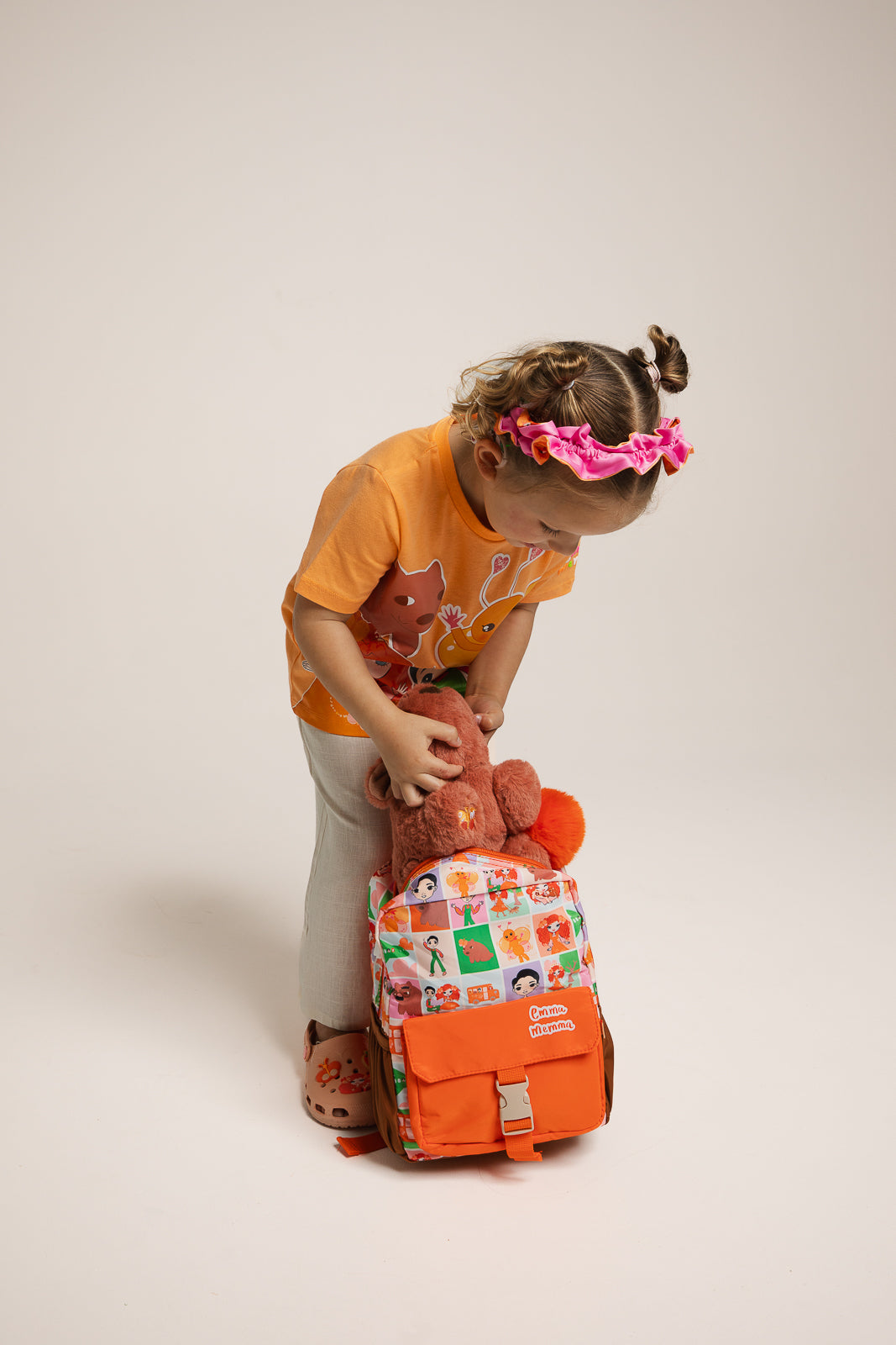 Child wearing Emma Memma Character Backpack from behind
